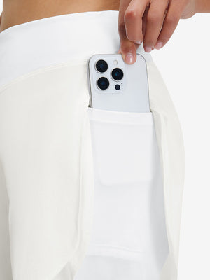 Detail view of side pocket on white women's gym golf shorts with liner pocket