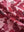 Close-up texture of red splatter women's sleeveless v-neck print golf shirts fabric showing printed weave detail.