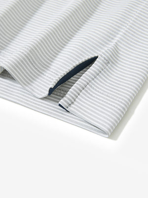 Detail view of hem on light grey white comfy breathable pin-stripe texture golf polos