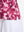 Detail view of hem on red splatter women's sleeveless q-zip print quick dry golf tops