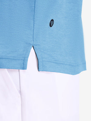 Hem detail close-up in blue heather of performance heather contrast collar polo shirts.