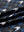Close-up of blue/black houndstooth full print lightweight quarter zip pullover fabric, soft and breathable texture