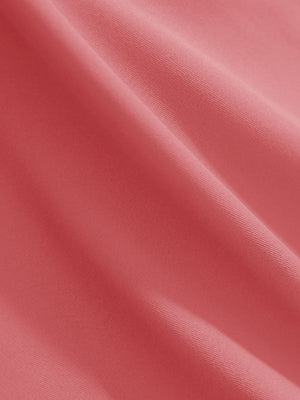 Close-up texture of pink women's 4 buttons golf polo shirts fabric showing detailed knit weave.
