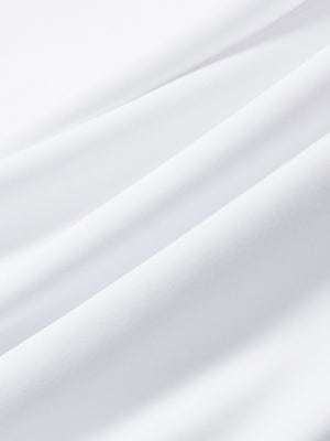 Close-up texture of white cool print plain button up shirts fabric showing detailed print and weave.
