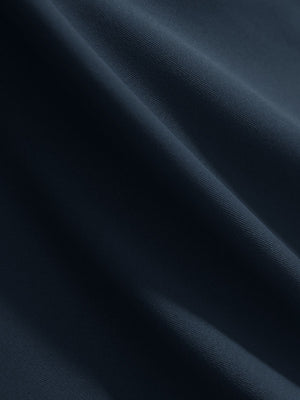 Close-up texture of navy women's 4 buttons golf polo shirts fabric showing detailed knit weave.