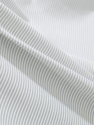 Close-up texture of light grey white comfy breathable pin-stripe texture golf polos fabric showing weave detail.