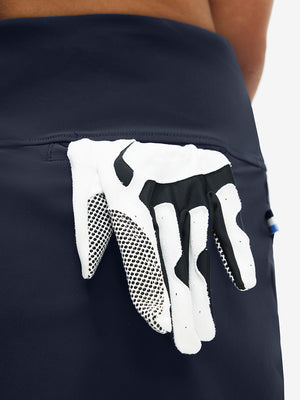 Back view of pocket on navy high waist built-in short a-line golf skirt with 5 pockets