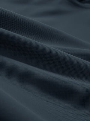 Close-up texture of dark grey dry fit waffle textured collared golf shirts fabric showing weave detail.