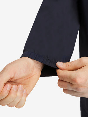 Detail view of cuff on navy waterproof lightweight rain jacket with hood