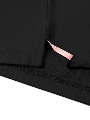 Hem detail close-up in black of nylon blend casual jacquard polo shirts.