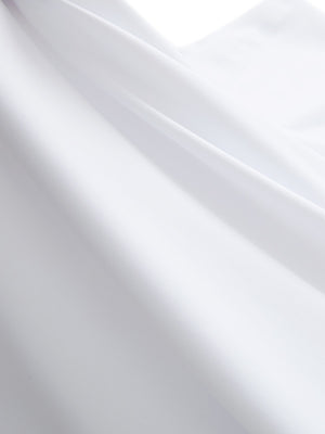 Close-up texture of white women's moisture-wicking mock neck sleeveless golf tops fabric showing breathable weave detail.
