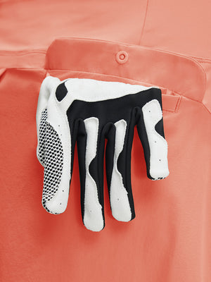 Detail view of pocket on peach pink women's stretch a-line golf skort with 7 pockets