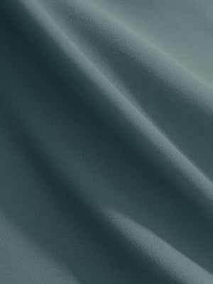 Close-up texture of dusty blue women's 4 buttons golf polo shirts fabric showing detailed knit weave.