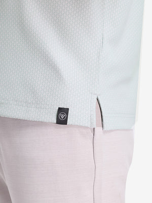 Detail view of hem on light grey moisture wicking jacquard golf shirts