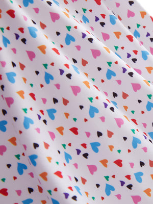 Close-up texture of colorful hearts women's sleeveless q-zip print quick dry golf tops fabric showing detailed print and quick dry weave.