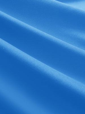 Close-up texture of sky blue women's 5 buttons collared polo shirts fabric showing detailed knit weave.