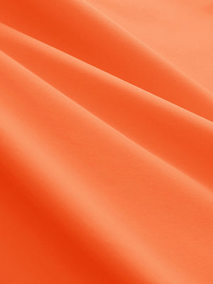 Close-up texture of orange women's 5 buttons collared polo shirts fabric showing detailed knit weave.