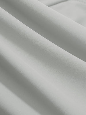 Close-up texture of silver gray women's high waist stretch golf pants with pockets fabric showing weave detail.