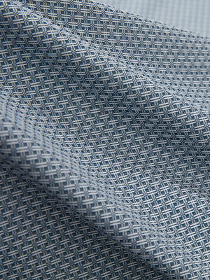 Close-up texture of misty blue moisture wicking jacquard golf shirts fabric showing detailed jacquard weave and wicking texture.