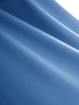 Close-up texture of light blue women's high waisted golf skirts with 4 inner pockets fabric showing detailed material and weave.