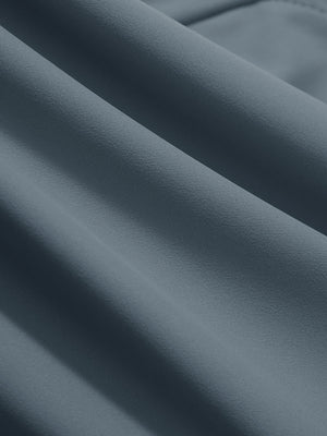 Close-up texture of grey blue women's high waist stretch golf pants with pockets fabric showing weave detail.