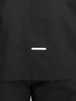 Back hem reflective detail of dark grey waterproof lightweight rain jacket with hood