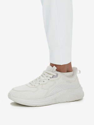 Detail view of hem on white women's lightweight athletic sweatpants
