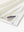 Close-up of hem slit detail in CREAM Premium Performance Polo