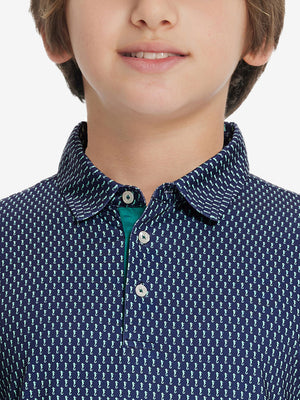 Front view of youth wearing green seahorse performance print boys golf polo, showing collar and chest fit