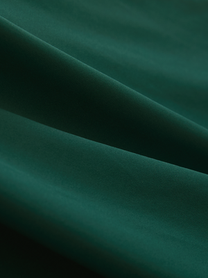 Close-up of the smooth cotton-blend fabric on the blackish green everyday classic solid polo
