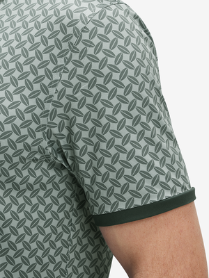 Detail view of cuff on dark green leaves stylish full print contrast collared golf polo shirts