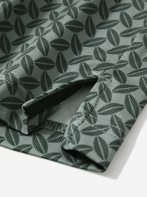 Detail view of hem on dark green leaves stylish full print contrast collared golf polo shirts