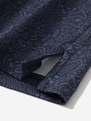 Detail view of hem on navy graffiti stylish full print contrast collared golf polo shirts