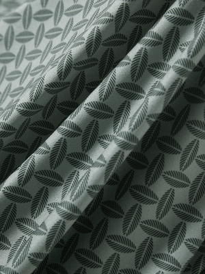 Close-up texture of dark green leaves stylish full print contrast collared golf polo shirts fabric showing weave detail.