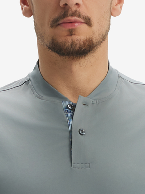 Close-up of model in grey moisture-wicking short sleeve henley shirt, nose to chest front view.